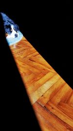 Close-up of cat on table against black background