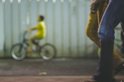 Low section of people on bicycle