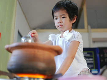 Girl cooking food in kitchen