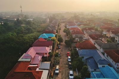 High angle view of houses against sky at sunset