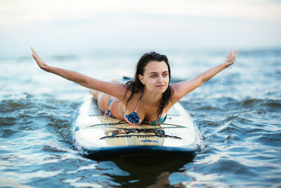 Portrait of young woman in sea