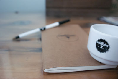 Close-up of cigarette and laptop on table