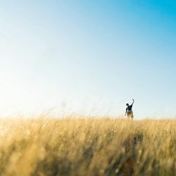 Man on field against clear sky