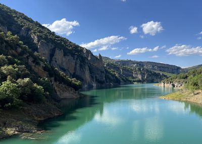 Scenic view of lake and mountains against sky