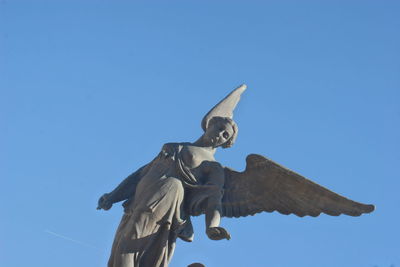 Low angle view of statue against clear blue sky