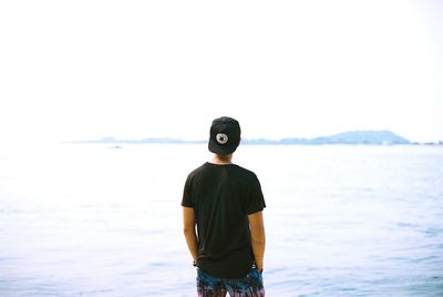 Young man standing on shore