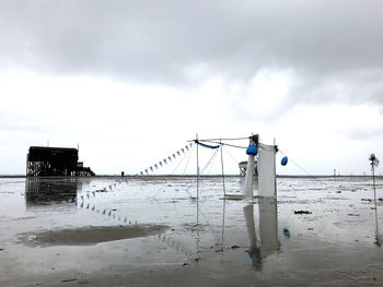 Man working on beach against sky