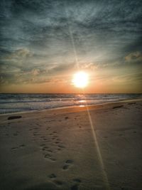 Scenic view of beach against sky during sunset