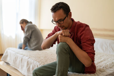 Frustrated cheated man husband thinking about betrayal, being betrayed by wife