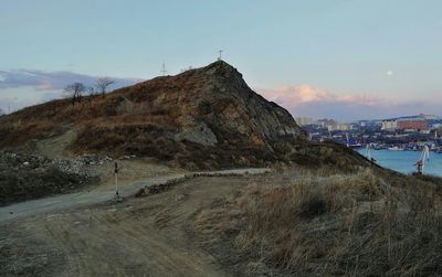 View of road by buildings against sky