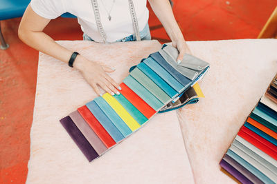 Midsection of woman holding books on table