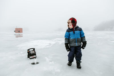 Portrait of boy standing in snow