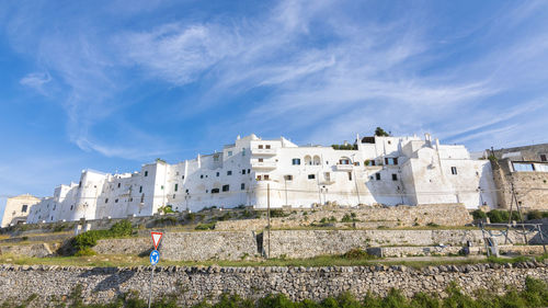 Woman by historic building against sky