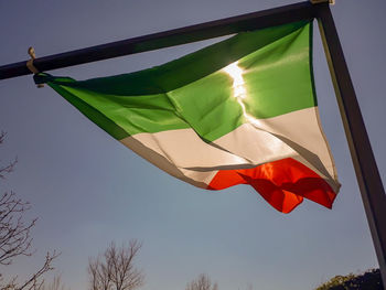 Low angle view of flag against sky