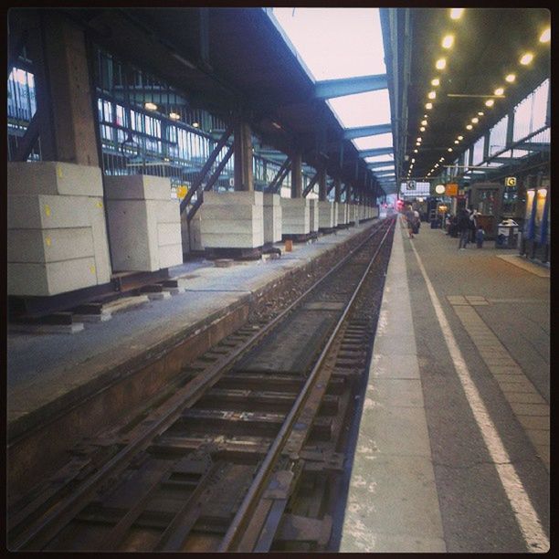 architecture, built structure, transportation, railroad track, railroad station, railroad station platform, illuminated, public transportation, building exterior, rail transportation, city, diminishing perspective, indoors, the way forward, incidental people, travel, transfer print, city life, auto post production filter, night