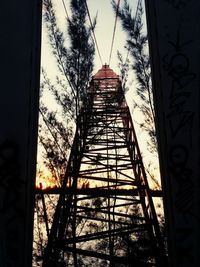 Low angle view of built structure against sky at sunset