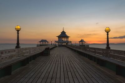 View of pier over sea against sky during sunset