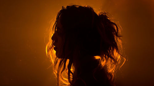 Close-up of silhouette woman against gray background