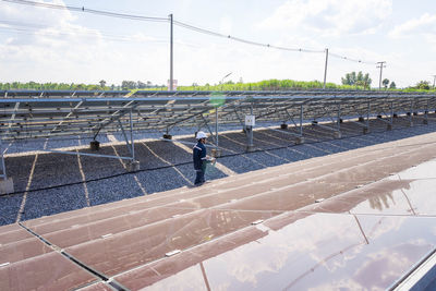 Man working against sky