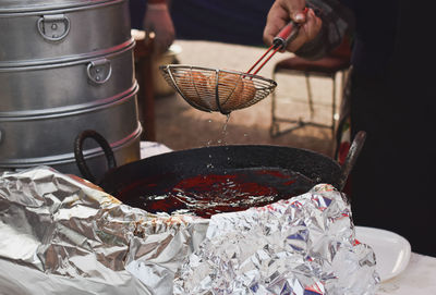 Close-up of person preparing food in kitchen