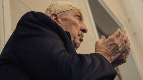 Close-up of man looking through window