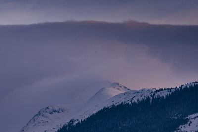 Scenic view of snowcapped mountains against sky during sunset