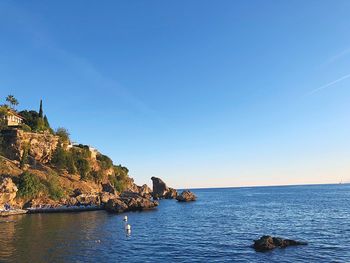 Scenic view of sea against clear blue sky