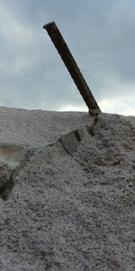 Low angle view of metallic structure on beach