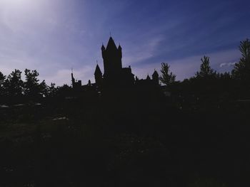 Low angle view of silhouette building against sky at dusk