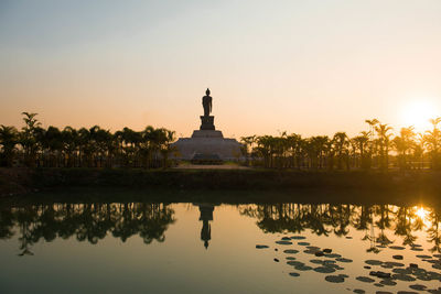 Reflection of building in lake during sunset