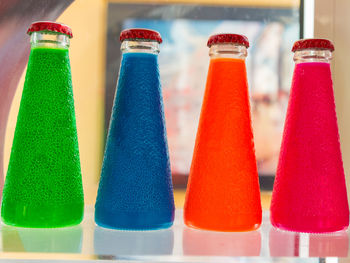 Close-up of multi colored bottles