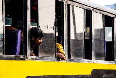 Man looking through train window