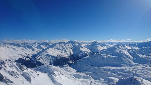 Scenic view of snowy mountains against cloudy sky