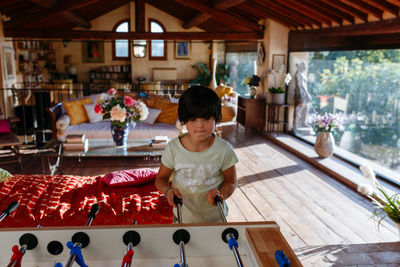 Upper view on girl playing table football