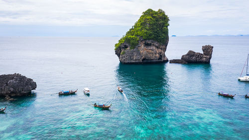 Adventure style hi season thai and foreign tourists long tail boat and driving see coral on phi phi 