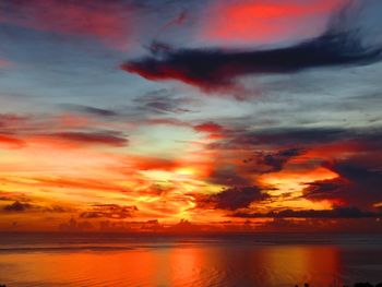 Scenic view of dramatic sky over sea during sunset