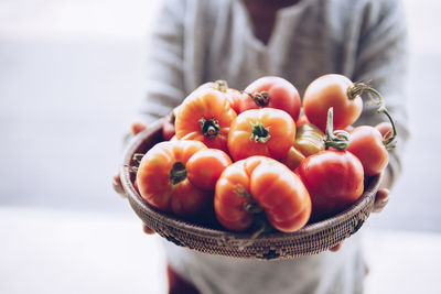 Close-up of hand holding tomatoes