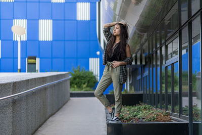 Woman standing against building