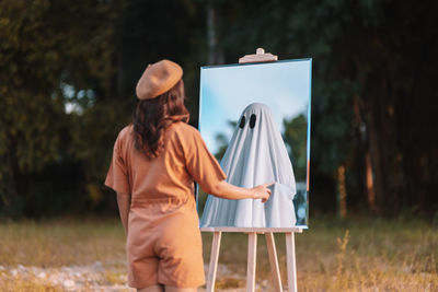 Rear view of woman standing in park