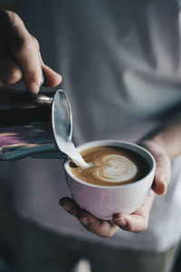 Midsection of woman holding coffee cup