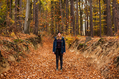 Full length of a man standing in forest