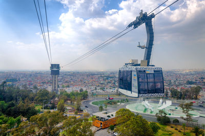 View of cityscape against cloudy sky