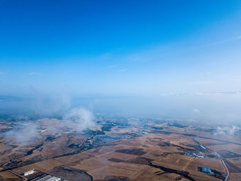 Aerial view of landscape against blue sky