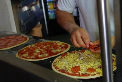 Midsection of man preparing food in restaurant