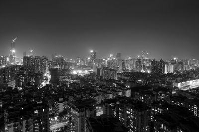 Illuminated cityscape against sky at night