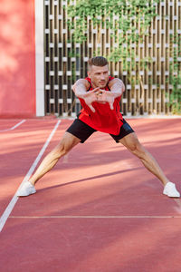 Young woman exercising on court