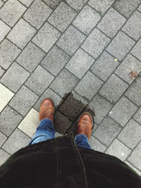 Low section of person standing on wet street