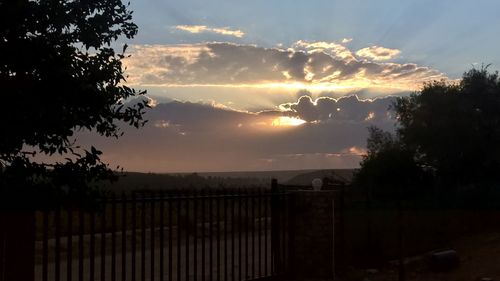 Scenic view of landscape against sky at sunset