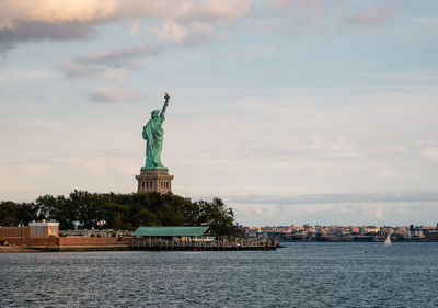 Statue of liberty against cloudy sky