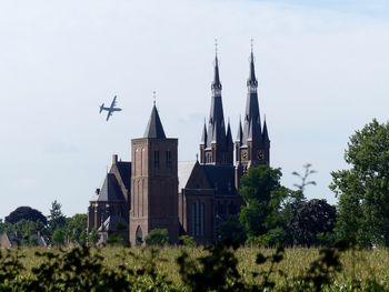 Low angle view of airplane flying against sky